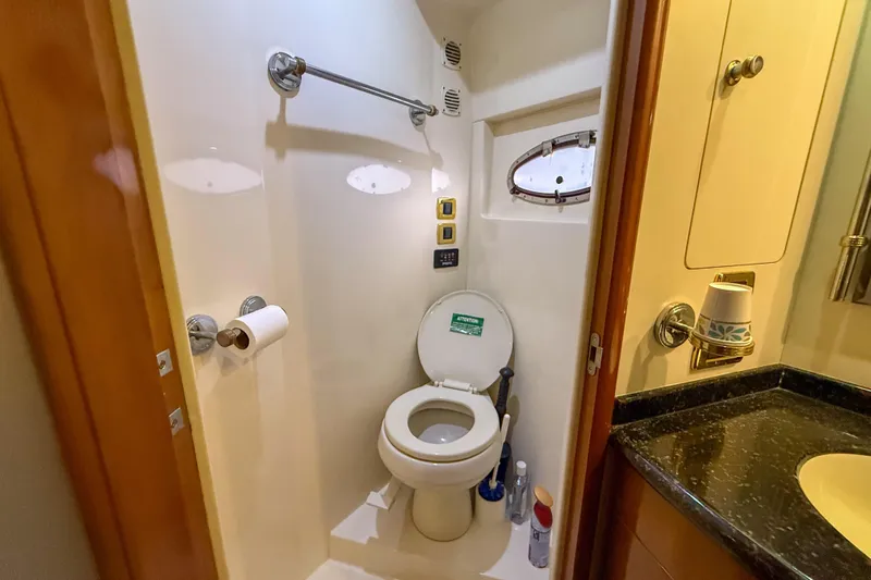 Over And Out Yacht Photos Pics Bathroom in 2001 Carver 570 Voyager Pilothouse yacht, featuring toilet and sink.