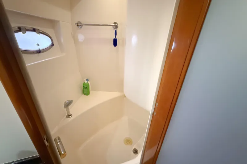 Over And Out Yacht Photos Pics Shower area in 2001 Carver 570 Voyager Pilothouse yacht with porthole and toiletries.