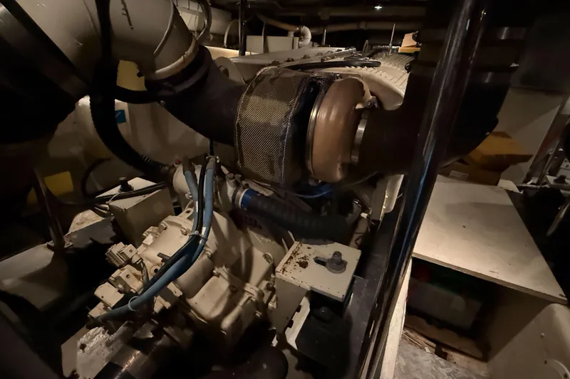 Over And Out Yacht Photos Pics Engine room of 2001 Carver 570 Voyager Pilothouse, showcasing mechanical components and piping.