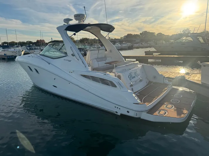 Pura Vida Yacht Photos Pics 2011 Sea Ray 330 Sundancer docked at sunset.