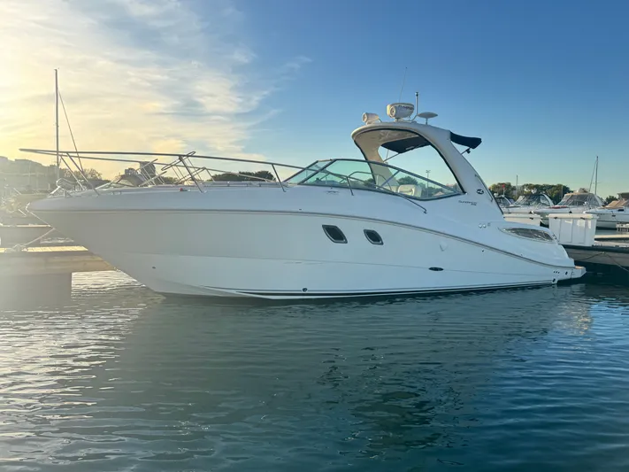 Pura Vida Yacht Photos Pics 2011 Sea Ray 330 Sundancer yacht docked at sunset.