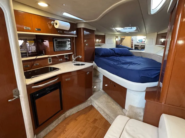 Pura Vida Yacht Photos Pics Interior of 2011 Sea Ray 330 Sundancer with kitchen and sleeping area.