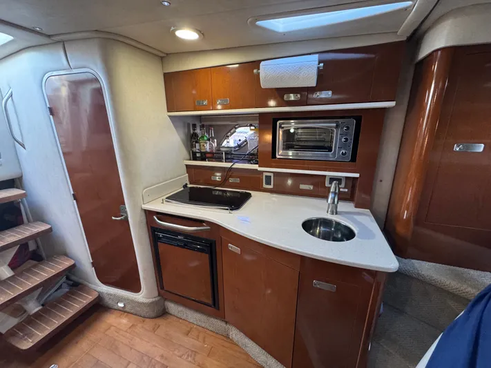 Pura Vida Yacht Photos Pics Interior of 2011 Sea Ray 330 Sundancer with kitchen area.