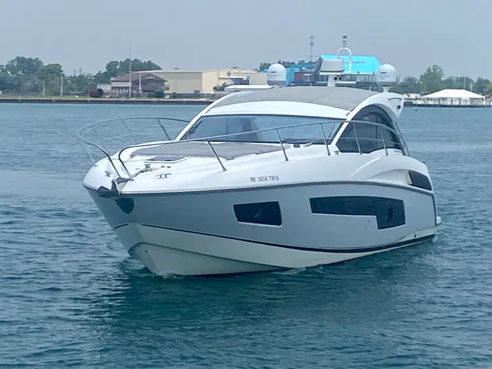 Work Hard, Play Hard Yacht Photos Pics 2013 Sunseeker Portofino 40 yacht cruising on calm waters.