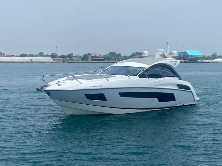 Work Hard, Play Hard Yacht Photos Pics 2013 Sunseeker Portofino 40 yacht on calm water, showcasing sleek design and luxury.