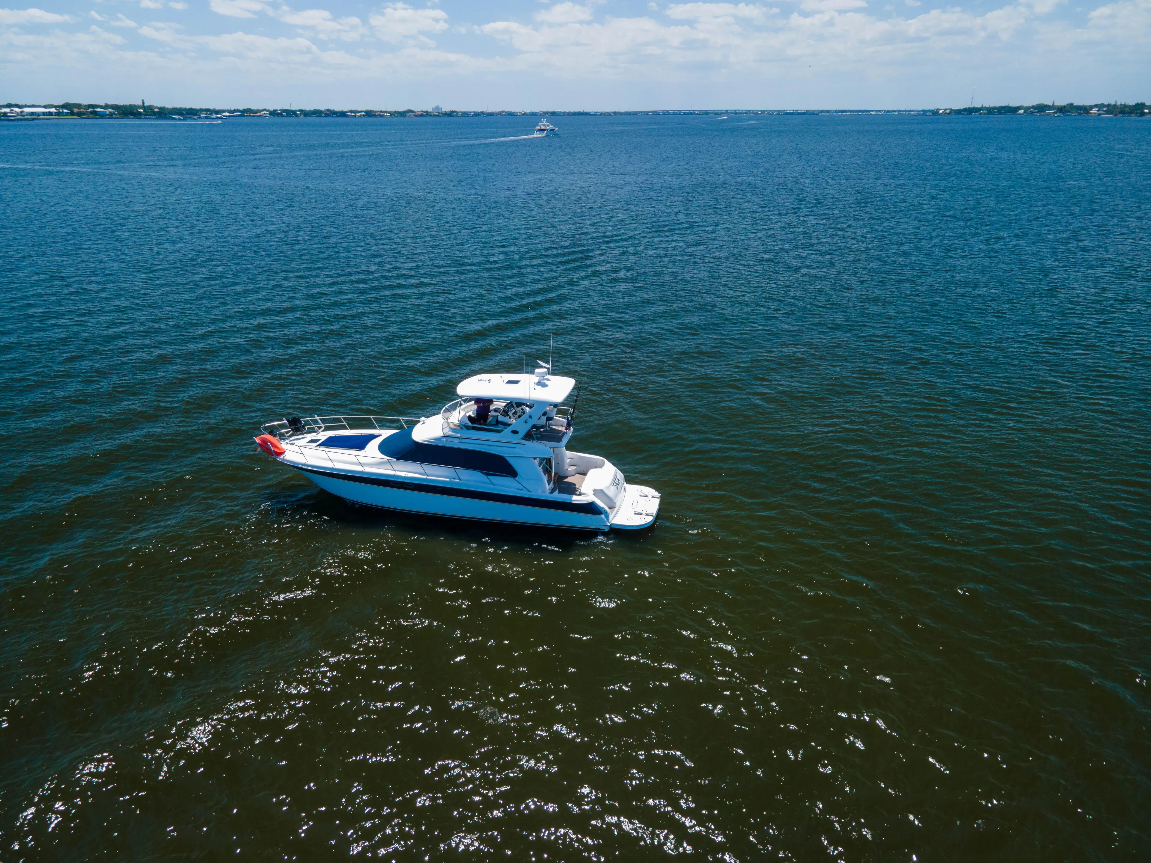 Saga Yacht Photos Pics 1999 Sea Ray 480 Sedan Bridge yacht cruising on open water.