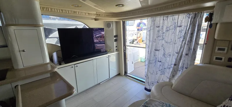 Saga Yacht Photos Pics Interior of 1999 Sea Ray 480 Sedan Bridge yacht with TV and elegant furnishings.