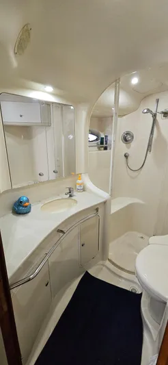 Saga Yacht Photos Pics 1999 Sea Ray 480 Sedan Bridge bathroom with shower, sink, and storage cabinets.