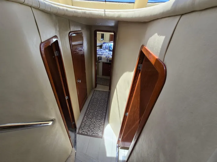 Saga Yacht Photos Pics Interior hallway of 1999 Sea Ray 480 Sedan Bridge yacht with wooden doors.