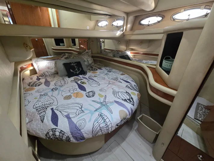 Saga Yacht Photos Pics Cozy bedroom in 1999 Sea Ray 480 Sedan Bridge yacht with nautical-themed bedding.