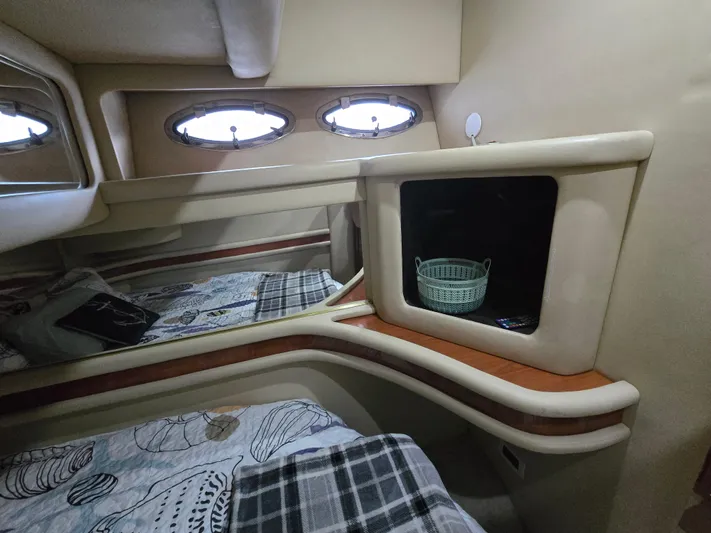 Saga Yacht Photos Pics 1999 Sea Ray 480 Sedan Bridge cabin interior with bed, storage, and porthole windows.