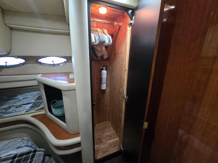 Saga Yacht Photos Pics 1999 Sea Ray 480 Sedan Bridge interior with open closet and cozy cabin features.