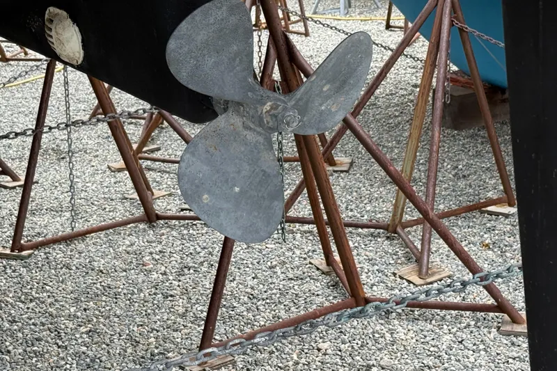  Yacht Photos Pics Propeller of 2023 Catalina 315 sailboat on stands, gravel background.