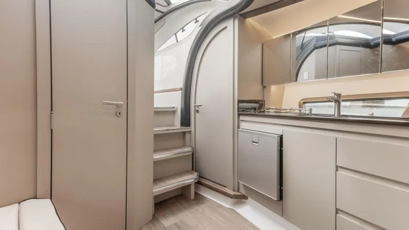 Custom Order Your 415 Today! Yacht Photos Pics Modern interior of 2025 Hanover 415 yacht with sleek kitchen and staircase design.