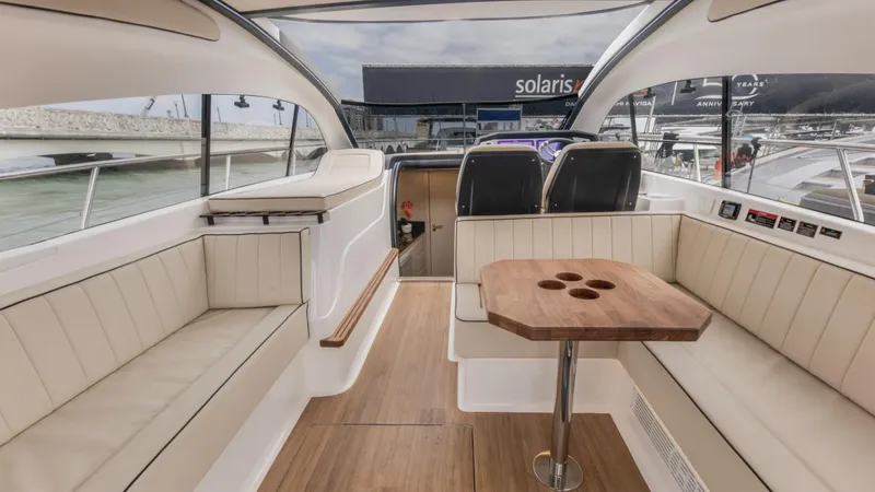 Custom Order Your 415 Today! Yacht Photos Pics Luxurious interior of 2025 Hanover 415 yacht with elegant seating and wooden table.