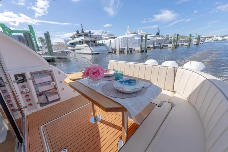 Custom Order Your 415 Today! Yacht Photos Pics Luxurious Hanover 415 yacht interior with elegant dining setup, docked at a marina, 2025 model.