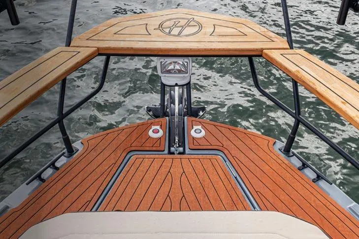 Custom Order Your 415 Today! Yacht Photos Pics 2026 Hanover 415 Outboard boat with elegant wooden deck design on water.