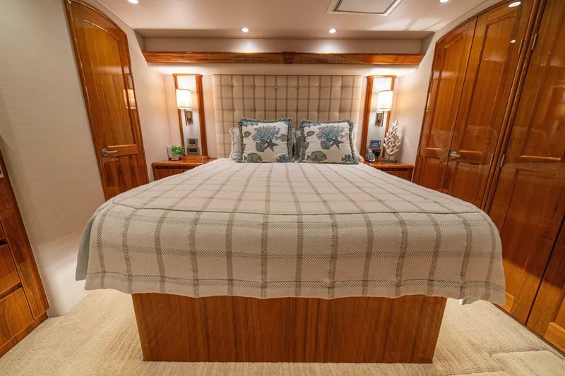 Watts Up Yacht Photos Pics Luxurious bedroom interior of 2016 Viking 66 Convertible yacht with elegant wood finishes.