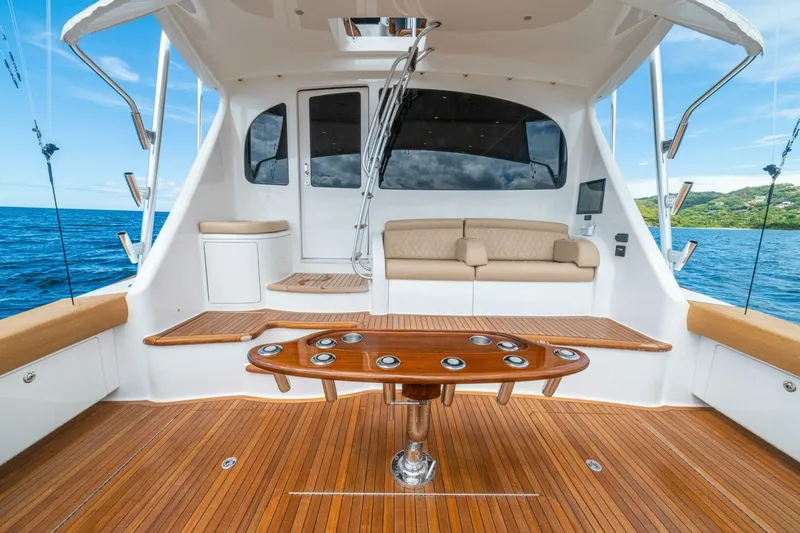 Watts Up Yacht Photos Pics Luxurious 2016 Viking 66 Convertible yacht interior with wooden deck and seating area.