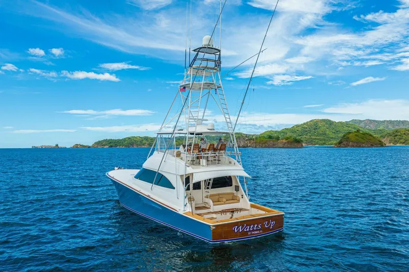 Watts Up Yacht Photos Pics 2016 Viking 66 Convertible yacht on blue ocean with scenic island backdrop.
