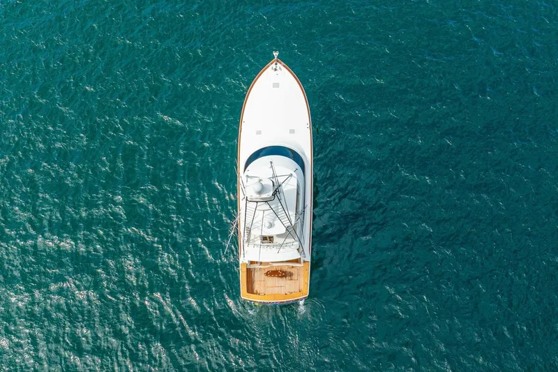 Watts Up Yacht Photos Pics Aerial view of 2016 Viking 66 Convertible yacht on blue ocean water.