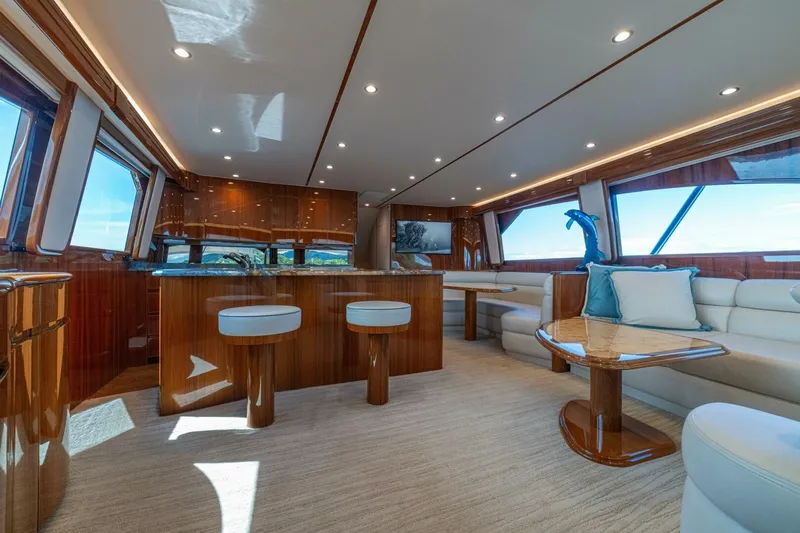 Watts Up Yacht Photos Pics Luxurious interior of 2016 Viking 66 Convertible yacht with elegant seating and wooden finishes.