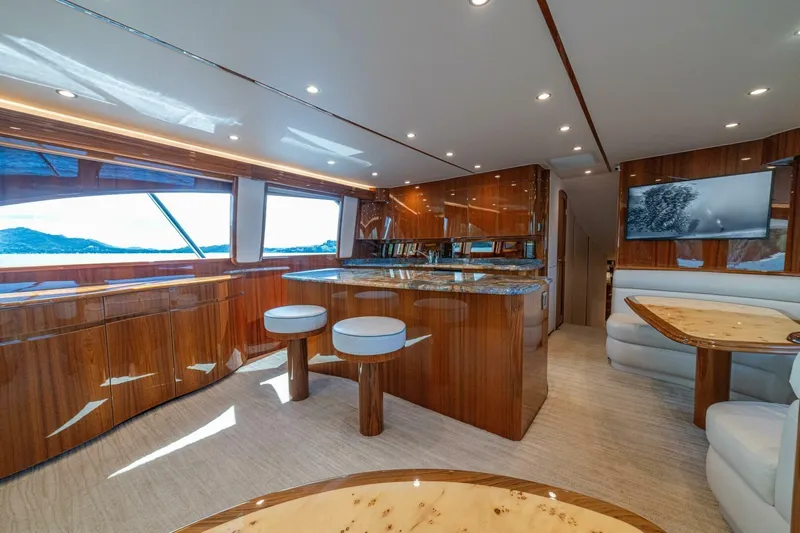 Watts Up Yacht Photos Pics Luxurious interior of 2016 Viking 66 Convertible yacht with elegant wood finishes and modern seating.