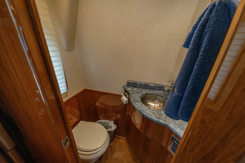 Watts Up Yacht Photos Pics Luxurious bathroom in 2016 Viking 66 Convertible yacht with wood accents and blue countertop.