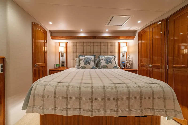 Watts Up Yacht Photos Pics Luxurious bedroom interior of 2016 Viking 66 Convertible yacht with elegant wood finishes.