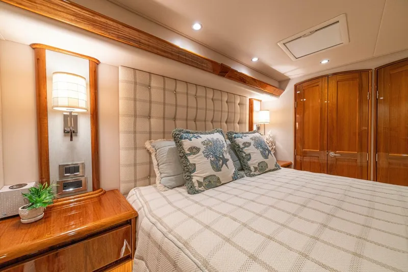 Watts Up Yacht Photos Pics Luxurious bedroom interior of 2016 Viking 66 Convertible yacht with elegant wood finishes.