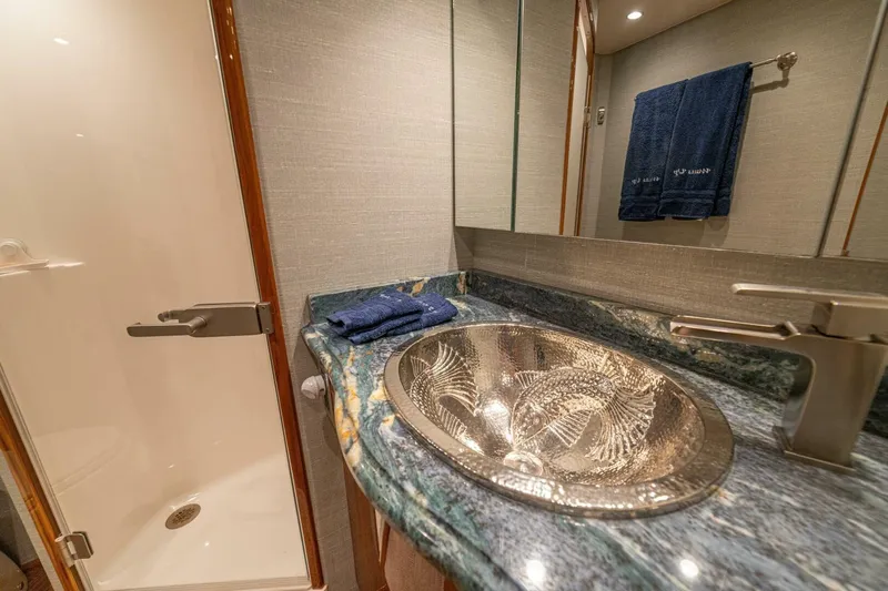 Watts Up Yacht Photos Pics Luxurious bathroom in 2016 Viking 66 Convertible yacht with elegant sink and modern fixtures.