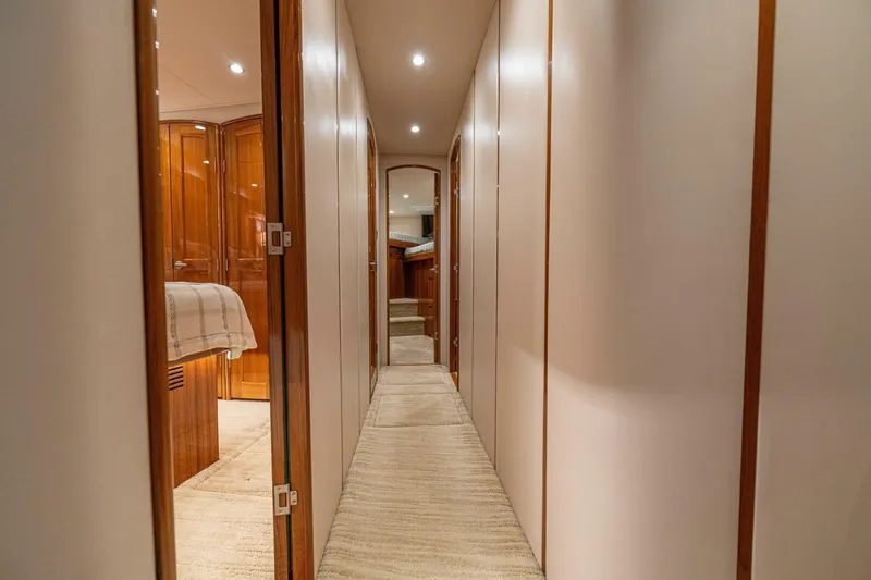 Watts Up Yacht Photos Pics Interior hallway of 2016 Viking 66 Convertible yacht, featuring elegant wood finishes and soft lighting.