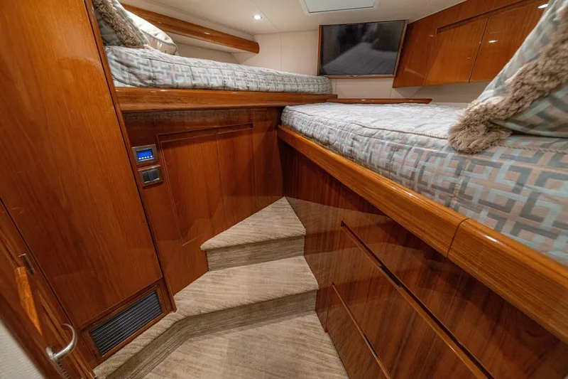 Watts Up Yacht Photos Pics Luxurious cabin interior of 2016 Viking 66 Convertible yacht with wooden finishes and twin beds.