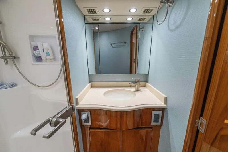 Watts Up Yacht Photos Pics Luxurious bathroom in 2016 Viking 66 Convertible yacht with modern fixtures and elegant wood cabinetry.