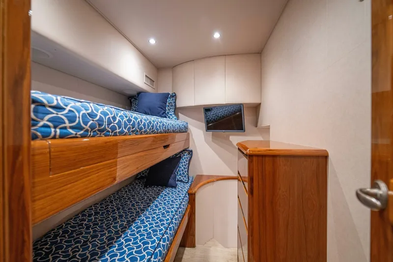 Watts Up Yacht Photos Pics 2016 Viking 66 Convertible yacht cabin with bunk beds and wooden cabinetry.