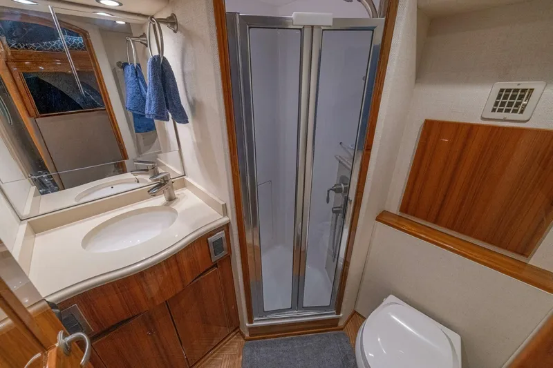 Watts Up Yacht Photos Pics Bathroom interior of 2016 Viking 66 Convertible yacht with shower, sink, and toilet.