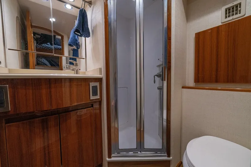 Watts Up Yacht Photos Pics Luxurious bathroom in 2016 Viking 66 Convertible yacht with wood accents and modern fixtures.