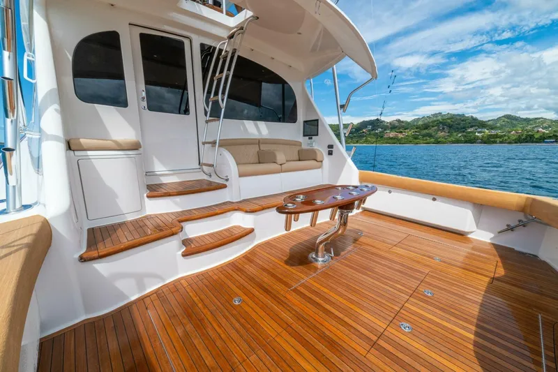 Watts Up Yacht Photos Pics 2016 Viking 66 Convertible yacht with teak deck, luxurious seating, and ocean view.