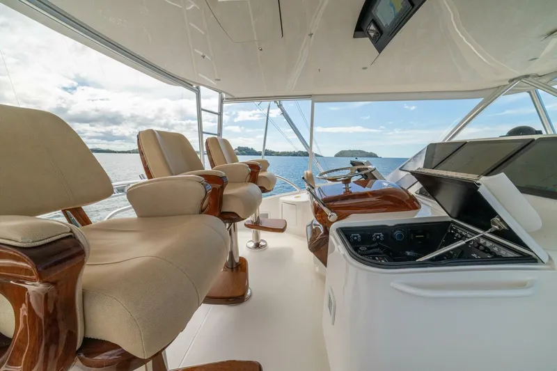 Watts Up Yacht Photos Pics Luxurious interior of 2016 Viking 66 Convertible yacht with plush seating and navigation controls.