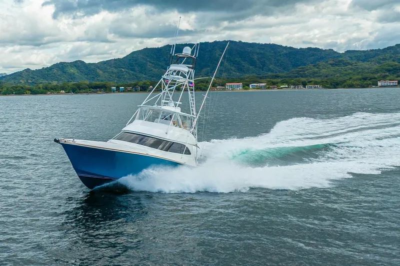 Watts Up Yacht Photos Pics 2016 Viking 66 Convertible yacht cruising on open water with scenic mountain backdrop.