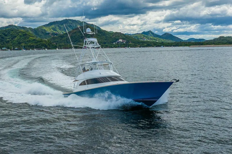 Watts Up Yacht Photos Pics 2016 Viking 66 Convertible yacht cruising on open water with scenic mountain backdrop.