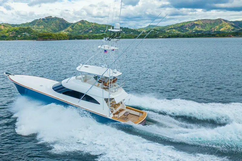 Watts Up Yacht Photos Pics 2016 Viking 66 Convertible yacht cruising on scenic waters with lush green hills.