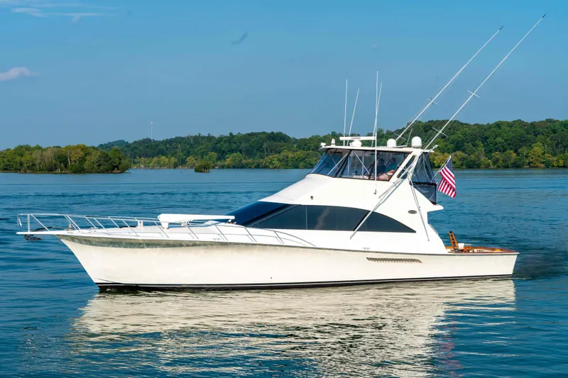  Yacht Photos Pics 1997 Ocean Yachts 60 Sport Fish boat on calm water with American flag.