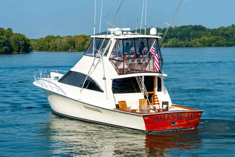  Yacht Photos Pics 1997 Ocean Yachts 60 Sport Fish boat cruising on a serene lake.