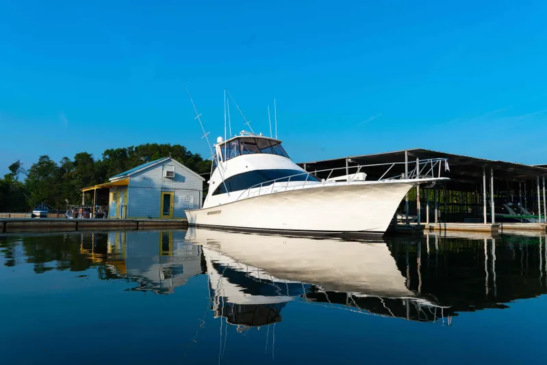  Yacht Photos Pics 1997 Ocean Yachts 60 Sport Fish docked by a marina under clear blue skies.