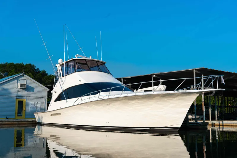  Yacht Photos Pics 1997 Ocean Yachts 60 Sport Fish boat docked on calm water under clear blue sky.