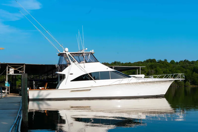  Yacht Photos Pics 1997 Ocean Yachts 60 Sport Fish boat docked on calm water under clear blue sky.