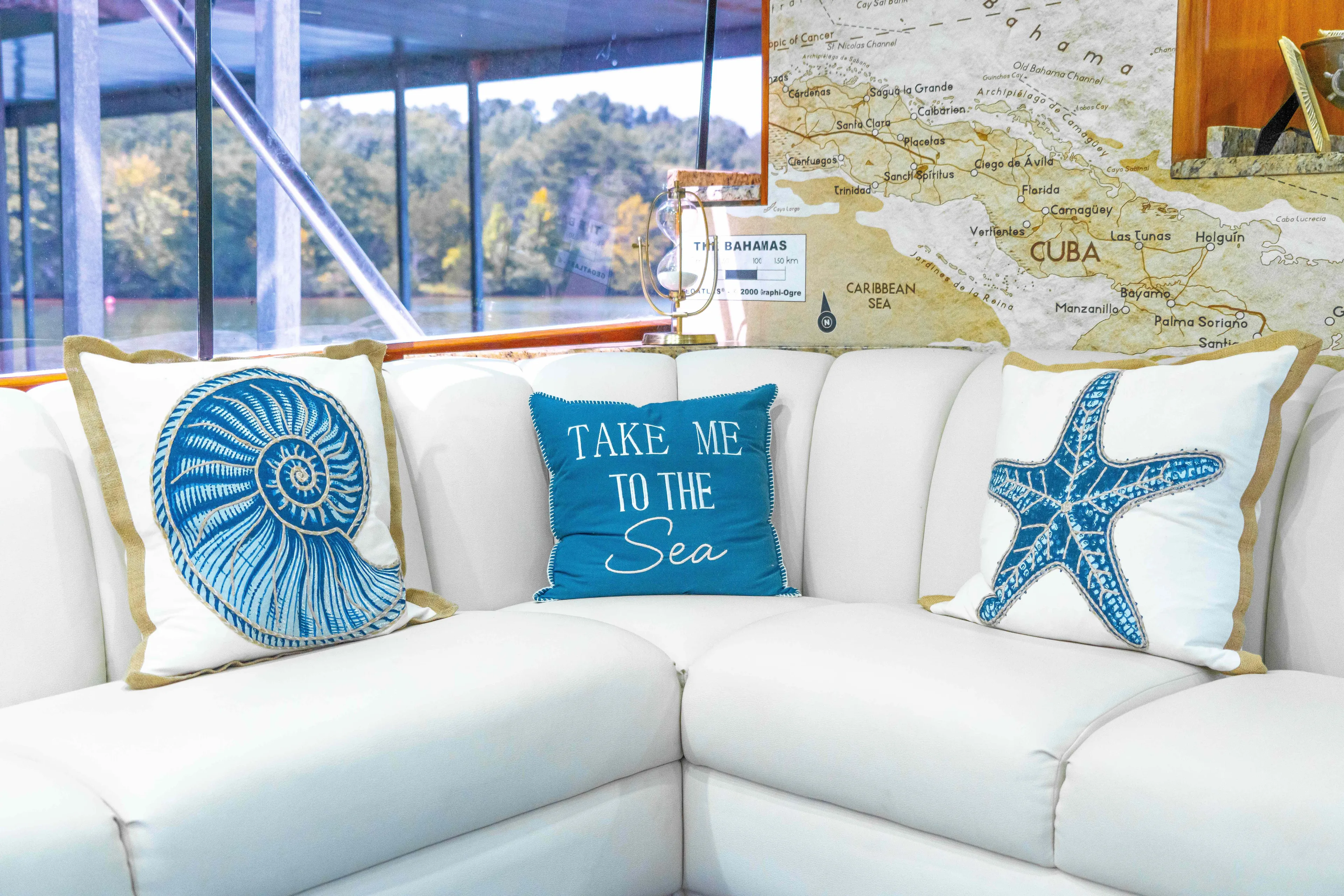  Yacht Photos Pics Cozy yacht interior with nautical-themed pillows on a white sofa, Ocean Yachts 60 Sport Fish.