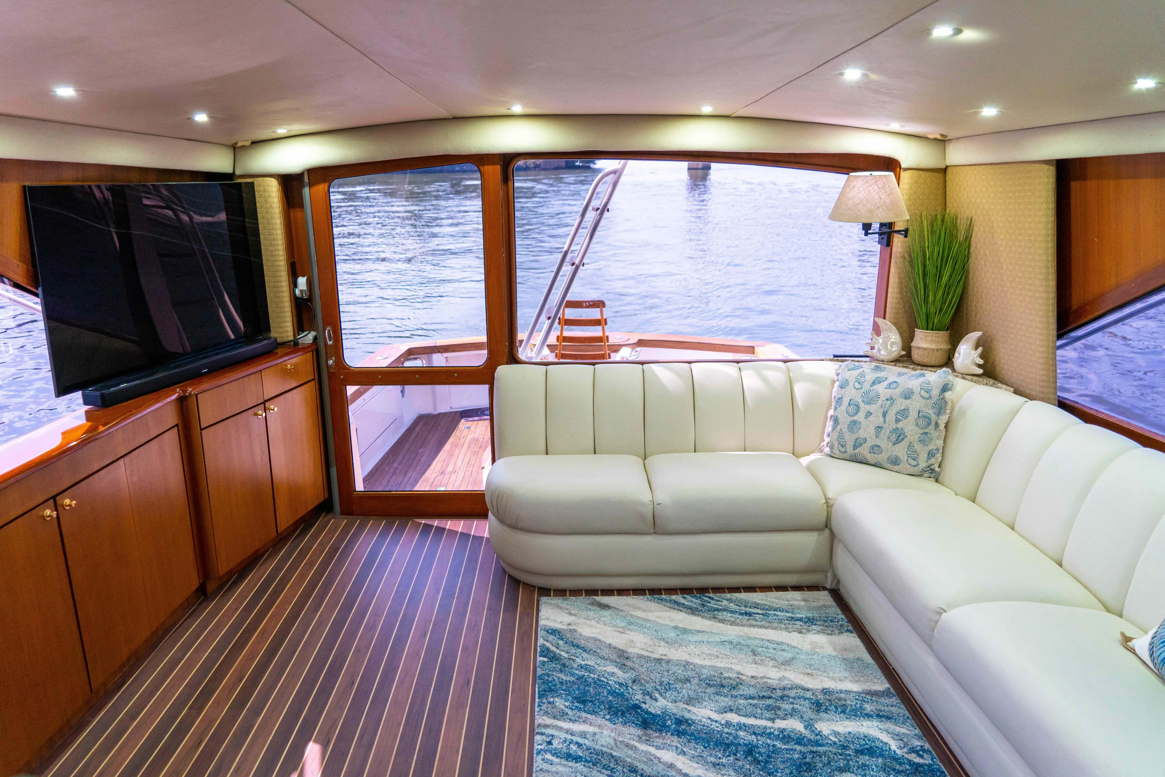  Yacht Photos Pics Luxurious interior of 1997 Ocean Yachts 60 Sport Fish with white sofa and large TV.