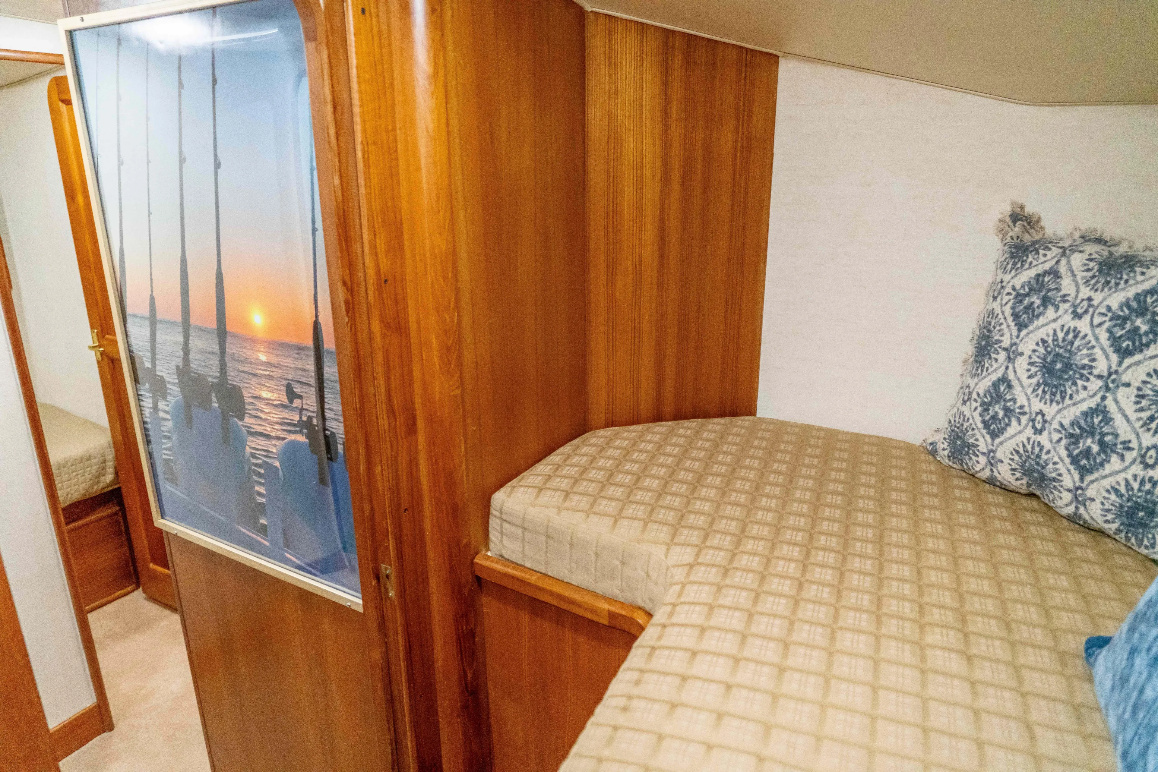  Yacht Photos Pics Interior cabin of 1997 Ocean Yachts 60 Sport Fish with cozy bedding and wooden finish.